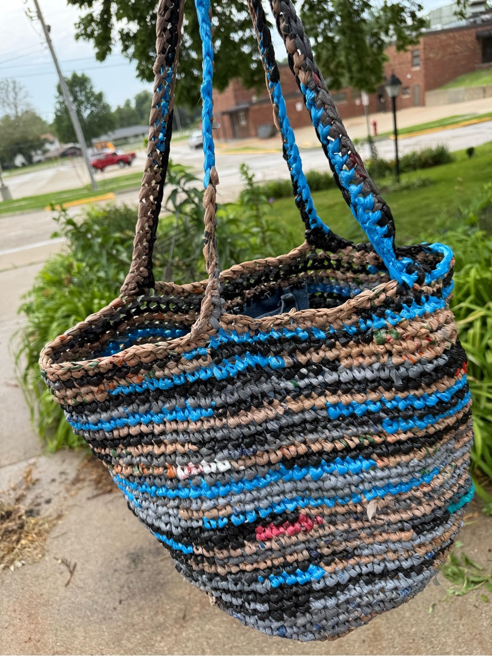 Handmade from plastic bags crocheted shopping tote bag with a pocket